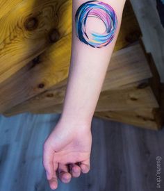 a woman's arm with a colorful tattoo on it