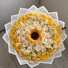 a bouquet of yellow and white flowers with congratulations written on it