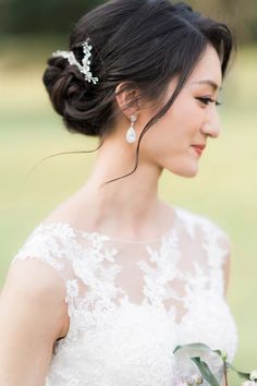 a woman in a wedding dress holding flowers