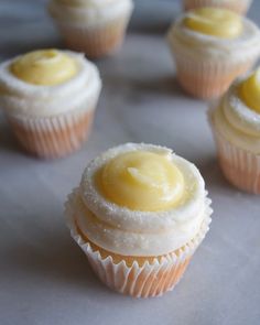 several cupcakes with frosting and yellow icing