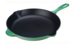 a green cast iron skillet on a white background