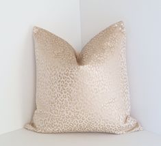 a leopard print pillow sitting on top of a white shelf