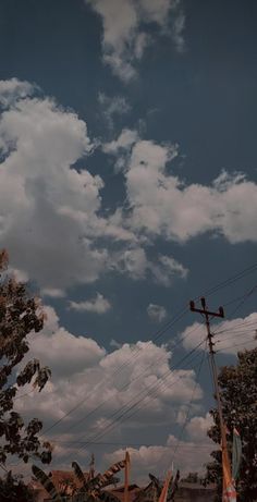 the sky is full of clouds and some power lines