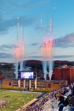 fireworks in the sky over a football field