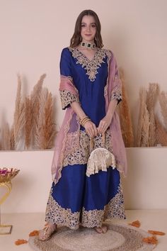 Blue kurta with floral, crescent moon embroidery using gota, zari and beaded work. Paired with a sharara with zari, floral embroidery on the hemline and baby pink dupatta with scallop trimmings. - Aza Fashions Blue Anarkali Raw Silk Palazzo Set, Blue Anarkali Style Raw Silk Palazzo Set, Blue Palazzo Set With Dabka Work For Reception, Royal Blue Cutdana Sets For Diwali, Blue Raw Silk Palazzo Set For Wedding, Blue Raw Silk Sharara With Gota Work, Anarkali Style Royal Blue Sharara With Dori Work, Royal Blue Sharara For Diwali Reception, Traditional Royal Blue Sharara For Designer Wear