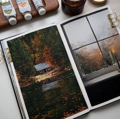 an open photo book on top of a table next to some paint and other items