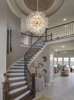 a large foyer with stairs and chandelier