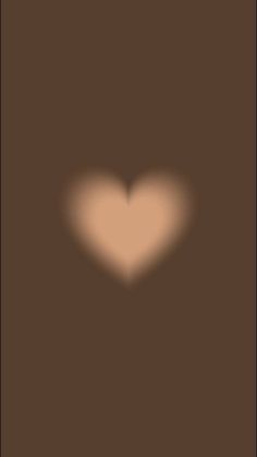 the shadow of a heart on a brown background