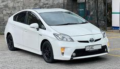 a white toyota prius parked in a parking lot