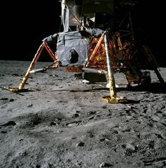 an astronaut standing on the moon next to a pole