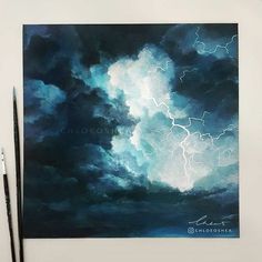 a painting of a storm in the sky with two paintbrushes next to it