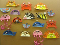 there are many different paper animals on the wall