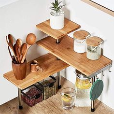 a wooden shelf with utensils on top of it