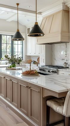 a kitchen with an island and two pendant lights