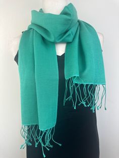 This scarf is imperfect, it has been discounted and is a FINAL SALE. It has slight discolouration which doesn't  impact its use in anyway please check pictures.  Beautiful 70% Pashmina and 30% Silk blend unisex neck scarf.  12"W X 60"L Hand wash or Dry Clean A timeless piece of accessory, this beautiful pashmina silk blend neck scarf will simply and effortlessly dress up and add style and class any outfit or coat. Folds and fits into your purse and wrinkles fall off easily. Perfect accessory for Green Pashmina Scarves For Winter, Green Pashmina Winter Scarf, Classic Solid Pashmina Shawl For Winter, Elegant Green Scarf For Winter, Elegant Green Winter Scarves, Elegant Green Winter Scarf, Pashmina Silk, L Hand, Neck Scarf