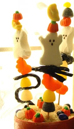 a cake decorated to look like halloween candy with ghost, pumpkins and jack - o'- lanterns