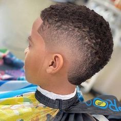 Check out the coolest black boys haircuts we have put together in our gallery. Here you will find a short curly hair mohawk with a fade, a low taper with curls, waves with a side part and many other trendy hairstyles for kids. #menshaircuts #menshairstyles #boyshaircuts #haircutsforboys #blackboyshaircuts Black Boys Mohawk Haircut Kids, Frohawk Fade Boys, Black Boy Fade Haircut, Black Boy Haircuts Kids, Curly Hair Fade Boys, Boys Haircut Black Kids, Black Boys Haircuts Kids Fade, Kids Mohawk Haircut, Haircut For Black Boys