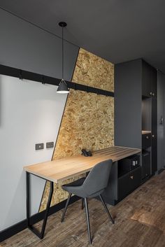 a wooden table sitting in front of a wall covered in wood planks and plywood