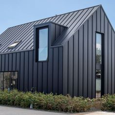 a black building with two windows on the side