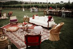 a living room filled with furniture on top of a grass covered field