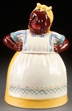 a ceramic figurine that is wearing a dress