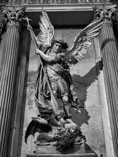 an angel statue on the side of a building