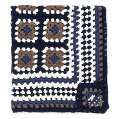 a crocheted blanket with brown and white flowers on the border is shown in front of a white background