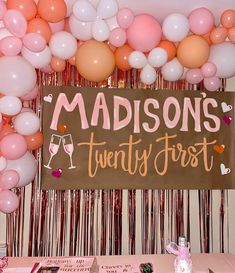 there is a sign that says madison's twenty first with balloons in the background