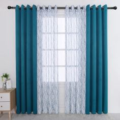 the blue curtains are hanging in front of a window