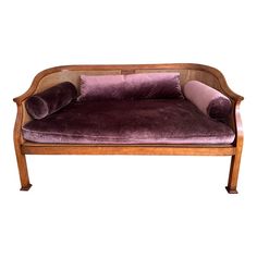 a purple couch sitting on top of a wooden frame