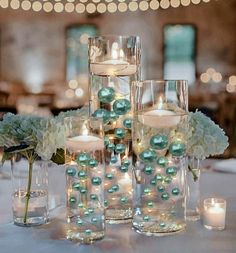 the centerpieces are filled with candles and flowers