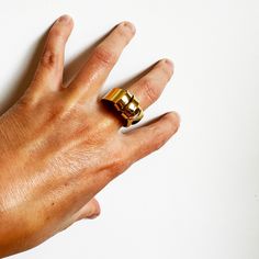 This was an exercise in patience. This ring is created out of a sheet of brass that I cut and split and wrapped back around. It's a sculptural and an unusual ring, but it's very comfortable to wear. About .75" wide at the bottom and varies around 1" at the top. Fabricated out of brass sheet and finished in 14k nickel free gold plate. Hand Forged Brass Open Ring, Unique Yellow Gold Wide Band Open Ring, Minimalist Hand Cast Gold Rings, Adjustable Brass Wide Band Open Ring, Adjustable Metal Wide Band Ring, Modern Brass Open Ring, Brass Open Band Metal Ring, Brass Open Band Metal Ring Jewelry, Gold Brass Dome Ring