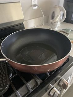 a frying pan sitting on top of an oven next to a stove burner