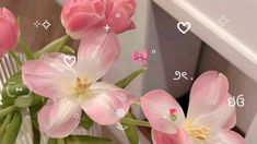 some pink flowers are in a vase on a table with numbers and symbols around them