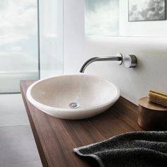 a bathroom sink sitting on top of a wooden counter