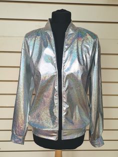 Holographic Silver Bomber style Jacket with sequin covered evil eye motif to the back of the jacket. Ideal for festivals and parties  Available in three sizes: SIZING S/M :    38-40" Chest   - Length  66cm    M/L :    42-44" Chest  -  Length 68cm        XL :    44-46" Chest - Length 71cm (length taken from back of neck to hem)  I have measured across the front of the jacket (laid flat with zip closed - underarm - underarm) If you are unsure what size to go for, you could compare these measurements with one of your jackets or shirts.  S/M :   56cm (22") M/L :  57cm (22.5")    XL :  58cm (23") Drop me a Etsy message if you have any questions about this jacket, or if you need any more measurements, and I will get back to you asap. I WILL DISPATCH YOUR ORDER WITHIN 3-5 DAYS, BUT IF YOU NEED IT Long Sleeve Outerwear For Party And Festival, Rave Long Sleeve Outerwear For Fall, Fall Rave Long Sleeve Outerwear, Fall Rave Outerwear With Long Sleeves, Fitted Disco Outerwear With Sequins, Fitted Sequin Disco Outerwear, Fitted Disco Outerwear For Party Season, Long Sleeve Sequined Outerwear For Festivals, Iridescent Fitted Long Sleeve Outerwear