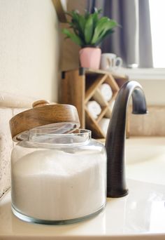 a bathroom sink with a soap dispenser next to it