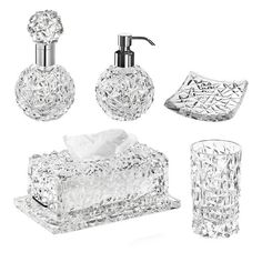 an assortment of crystal bathroom accessories including soap dispenser, toothbrush holder and tissue box