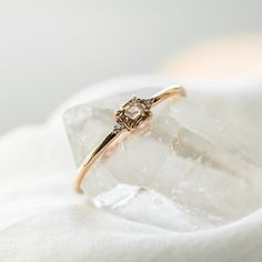 a diamond ring sitting on top of a rock