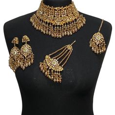 Asian jewellery set. Set includes- Necklace  Earrings  Jhumar  Tikka Gold Jewelry With Stone Work For Celebration, Festive Jewelry With Stone Work For Celebration, Gold Kundan Necklace With Stone Work For Festivals, Ceremonial Gold Kundan Necklace With Stone Work, Gold Kundan Necklace With Stone Work For Eid, Ceremonial Gold Kundan Necklace Hand Set, Gold Jewelry With Stone Work For Festivals, Traditional Gold Jewelry With Stone Work, Gold Bridal Necklace With Stone Work For Festive Occasions