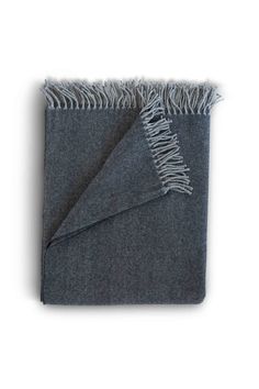 a blanket with fringes on the bottom and grey fabric in the middle, against a white background