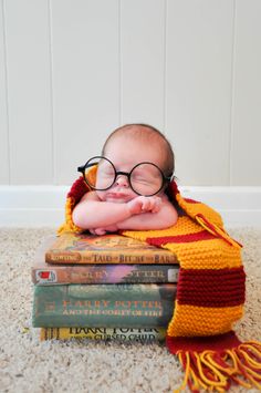 a baby wearing glasses is laying on some books