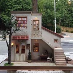 a doll house with stairs leading up to it