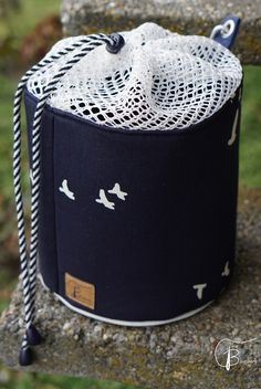 a black and white bag sitting on top of a rock