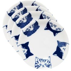 four blue and white plates with cats on them