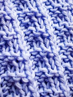 a close up view of a blue knitted blanket