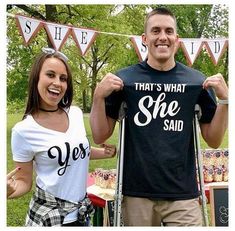 a man and woman standing next to each other in front of a sign that says, that's what she said