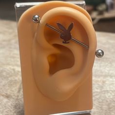 the ear is made out of plastic and has metal studs