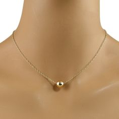 A simple yet elegant design.  This dainty and lightweight necklace is made with a 10mm 14k gold filled bead suspended on a 14k gold filled chain with a 14k gold filled lobster clasp. This necklace be worn with just about anything, from casual to dressy.  It can also be worn with longer necklaces for a layered look. Available in five necklace lengths.  Please choose the length that you need from the drop-down menu. The necklace will arrive in an attractive gift box. Minimalist 14k Gold Filled Round Bead Necklaces, Minimalist Single Strand 14k Gold Filled Necklace, Minimalist 14k Gold Filled Single Strand Necklace, Teardrop Pearl Earrings, Cloisonne Jewelry, Jewelry Lockets, Gold Bead Necklace, Necklace Minimalist, Photo Locket