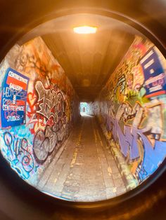 a tunnel with graffiti all over it